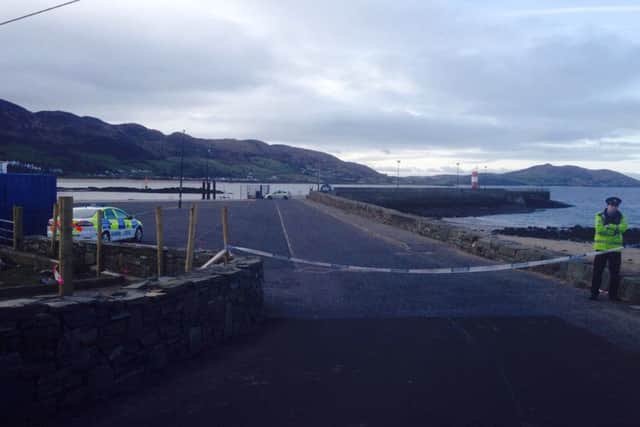 A garda officer at the cordon erected at Buncrana Pier on Monday morning.