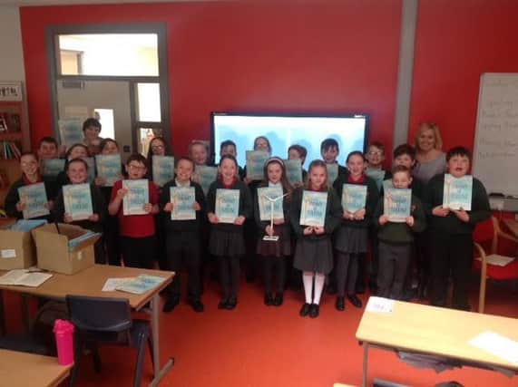 Primary seven pupils from Eglinton Primary School pictured with their copies of 'Tommy the Turbine.'