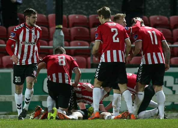 Derry City players celebrate victory.