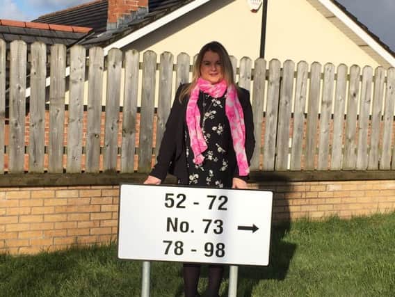 Sinn Fein Councillor Sandra Duffy with some of the new signage.
