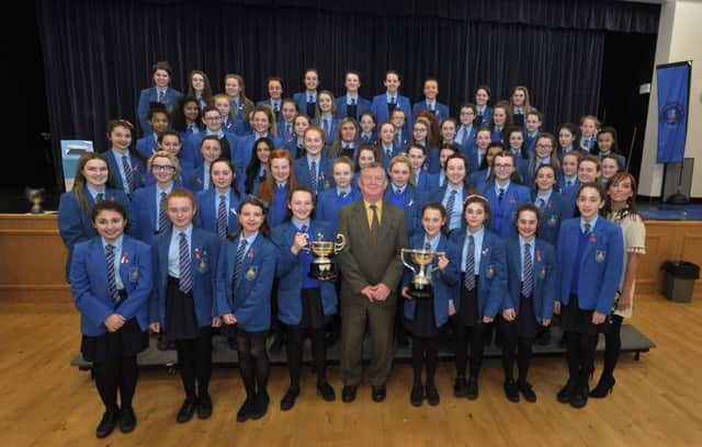 Adjudicator Dr McKee from Belfast pictured with St MaryÃ¢Â¬"s College choir who came first in the Post Primary Unison Cup, the Two-Part McDonald Cup and The Thornhill Past Pupils Union Cup at the Derry Feis Post Primary competition held in St MaryÃ¢Â¬"s College Derry on Tuesday last. DER1216GS012