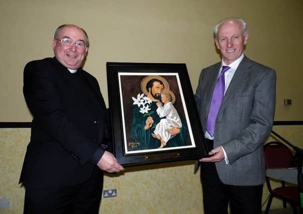 Fr Devlin P.P Malin with Richard Doherty whoes family donated the painting in memory of their family. Photo: Joseph Jackie.