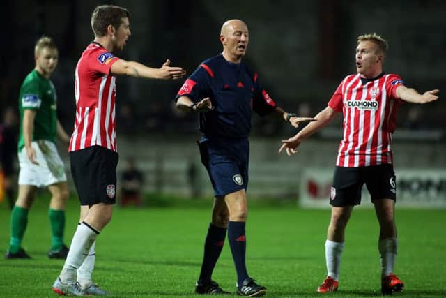 Â©/Presseye.com - 18th February 2012.  Press Eye Ltd - Northern Ireland - SSE Airtricity League Premier Division - Derry City V Bray Wanderers.

Derry's Patrick McEleney and Conor McCormack with math referee Paul Tuite.

Mandatory Credit Photo Lorcan Doherty / Presseye.com