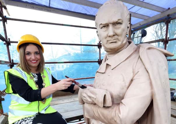 Mayor of Derry City and Strabane District, Councillor Elisha McCallion, examines the restoration work so far on the statue