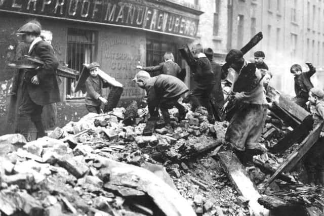 Poor children of Dublin collecting firewood from the ruined buildings damaged in the Easter Rising.