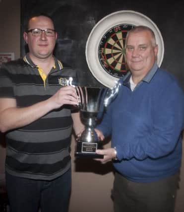 James Clancy, captain, Mailey's Bar pictured receiving the Jackie Doherty Memorial Cup (sponsored by the Phoenix Bar),  from Philip Oakes, Chairman, Estate Services Friday Night Darts League. DER1316MC150