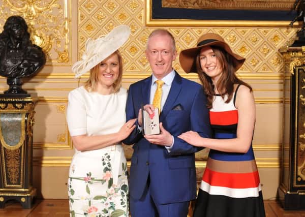 Eddie Lynch, pictured with his wife Jane and daughter Bridget at Windsor Castle on 13th April where he received his MBE award from the Queen. Photo: PA
