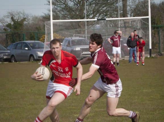 Dolan's Alan Grant collects possession after breaking down a Slaughtneil attack during Sunday's clash at Ballyarnett. DER1416MC064