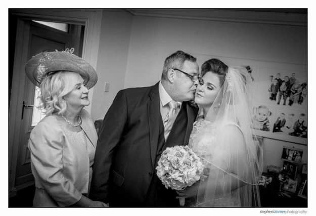 A kiss from Daddy. Charlene, her mum Bridgeen and her Dad Charlie.