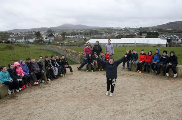 Courtney Gallagher, Craigtown National School celebrates the opening of the new park in Carndonagh, surrounded by classmates. At back are Laura Duncan, parent, Mrs. Brigid McGonigle, teacher and Demi Baker, classroom assistant. DER1115MC122