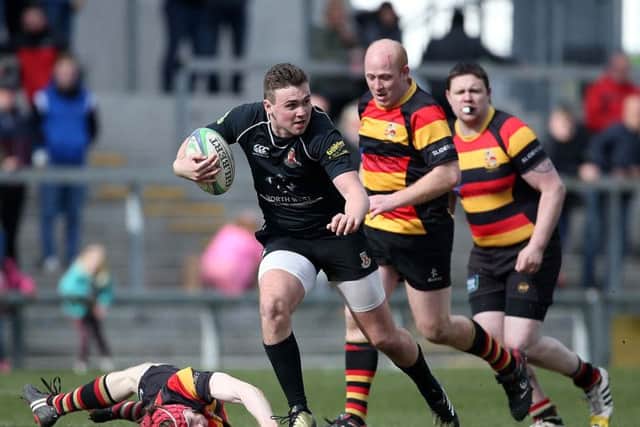 Limavady's Jamie 'Mo' Millar gets away from 

Lurgan's Daniel Lyness during Saturday's Gordon West Final at Kingspan Stadium.
 (Picture by Brian Little/Presseye)
