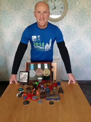 Jackie Doherty pictured with the many medals he has won over the years.