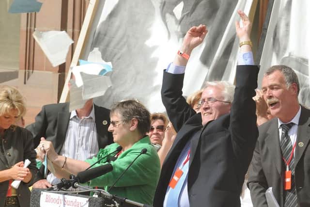 John Kelly with his arms raised alongside other relatives following the publication of the Saville Report in June 2010.