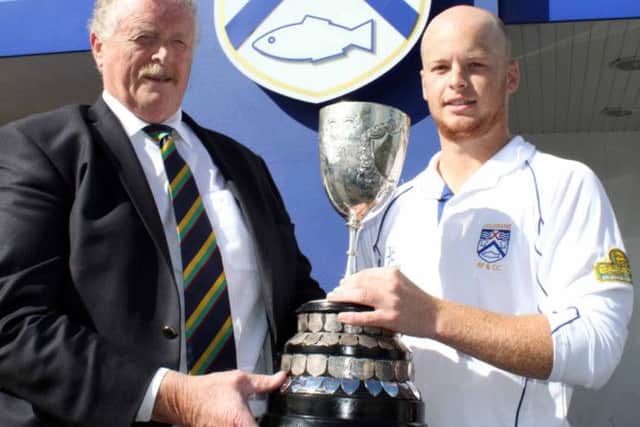 NW Cricket President, John McMillan, presents Long's Supervalu NW Premiership trophy to Scott Campbell, captain of Coleraine after last season's success.