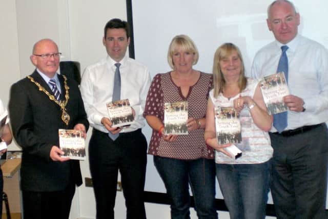 Members of the Hillsborough Families Support Group holding the book Setting the Truth Free by Derry journalist Julieann Campbell on their visit to the city in 2012. The visit was facilitated by Foyle MP Mark Durkan. Also pictured is current Shadow Home Secretary Andy Burnham MP.