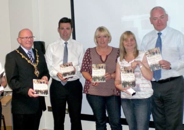 Members of the Hillsborough Families Support Group holding the book Setting the Truth Free by Derry journalist Julieann Campbell on their visit to the city in 2012. The visit was facilitated by Foyle MP Mark Durkan. Also pictured is current Shadow Home Secretary Andy Burnham MP.