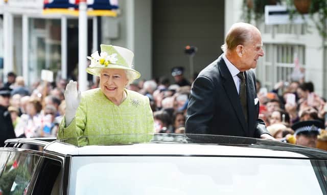Queen Elizabeth II and the Duke of Edinburgh ride in an open-topped Range Rover close to Windsor Castle in Berkshire as she celebrated her 90th birthday last Thursday. (John Stillwell/PA Wire)
