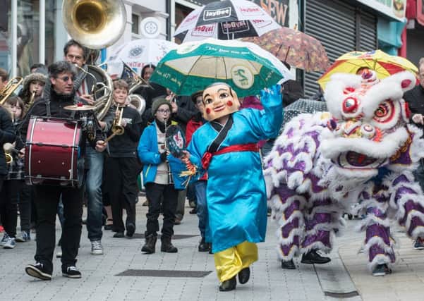 A chinese dragon and character add a carnival twist to the the DLD line parade in Derry as part of the City's annual Jazz and Big Band Festival which is now in its 15th year. Picture Martin McKeown. Inpresspics.com. 30.04.15