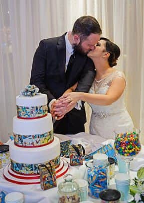 Sweet! A couple cut their comic book cake surrounded by sweets with the help of Wicked Weddings. (Picture by David McAuley Photography)