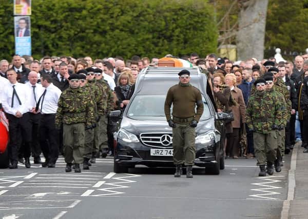 A guard of honour flanks the coffin of Michael Barr at his funeral in Strabane Co Tyrone this morning