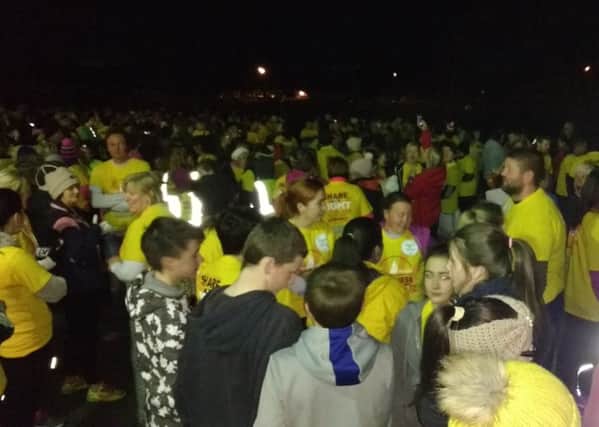 The fantastic turnout at Saturday's Darkness Into Light Walk in Buncrana gather for the start of the walk.