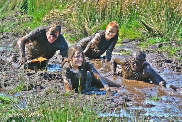 Competitors make their way through the mud at Hard as Oak.
