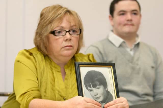 Helen Deery, the sister of Manus Deery, holding a picture of her brother at a press conference highlighting his case.