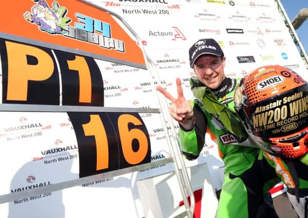 Alastair Seeley celebrates winning the opening Supersport race during the first Supersport race at the North West 200.