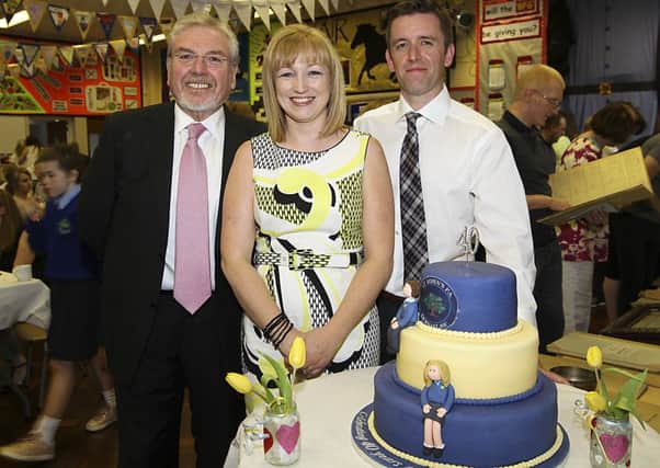 Former school principal Mr Hilary McCloskey with Jeanette Kelly (who baked the celebratory cake) and present school principal Mr John J McWilliams at the St Johns Primary School Dernaflaw 40th Anniversary celebrations this week. INLV1916-404KDR Photos by Ken Reay