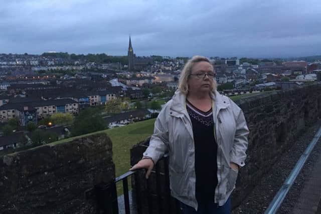 Helen Deery pictured on Tuesday night on the city's walls close to the spot where the Brititish Army bullet that killed her 15-year-old brother Manus was discharged on May 19, 1972. The killing is the subject of an investigation and should be the subject of a fresh inquest this year.
