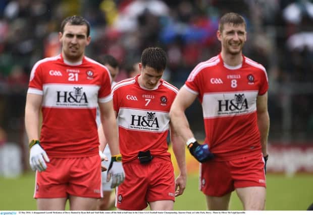 A disappointed Gareth McKinless of Derry flanked by Ryan Bell and Niall Holly comes off the field at half time in the Ulster GAA Football Senior Championship, Quarter-Final, at Celtic Park, Derry. ( Photo by Oliver McVeigh/Sportsfile)