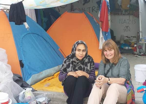 Hilda pictured with one of the refugees i n a makeshift camp in Athens.