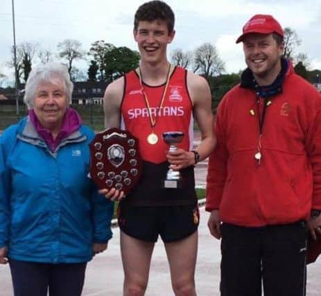 City of Derry's Fintan Stewart, winner of Paddy O 'Donnell male 800m race,  with Paddy's wife, Mary, and son, Martin O  Donnell at Templemore track.