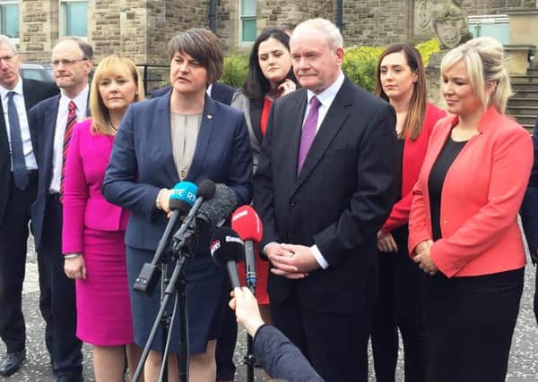 First Minister Arlene Foster and Deputy First Minister Martin McGuinness and the new-look Stormont Executive outside Stormont Castle yesterday.