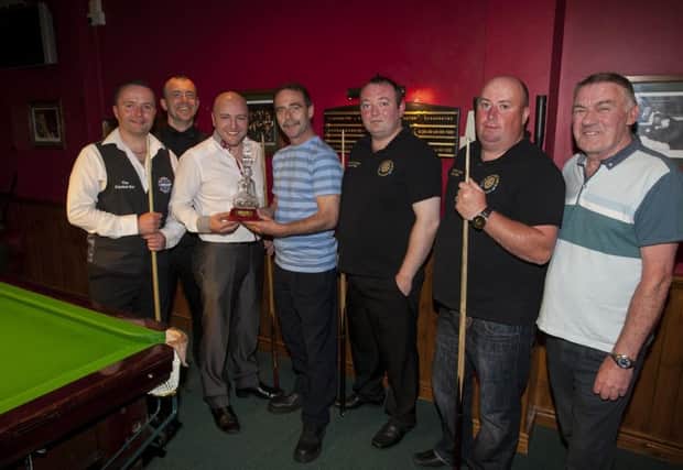 Harry Logan presenting the Senior Pairs Snooker Championship trophy to Adrian McFadden and Gareth Kirwan, CYMS, Letterkenny at Tracy's Bar, William Street on Wednesday night last. Included from left are Seamus Gallagher, referee, Peter Doherty and Joe Porter, Shantallow House, beaten finalists, and Joe Sims, referee. DER2116MC004