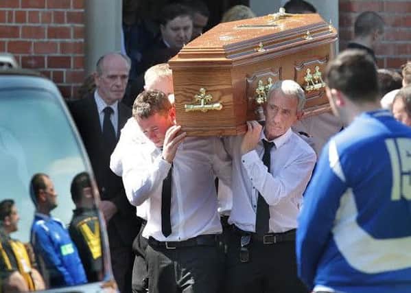 The remains of Gerard Quinn are carried by moruners at his funeral on Sunday.