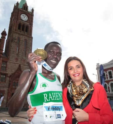 Freddy Sittuk from Kenya, winner of the 2015 Walled City Marathon receives his medal from mayor Elisha McCallion in Guildhall Square on Sunday.