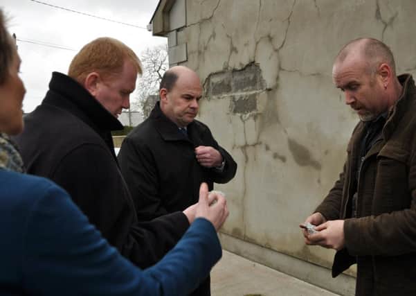 (L-R): Ann Owens (MAG), Minister Paudie Coffey, Damien Mc Kay (Structural Engineer) and affected homeowner Oliver Lafferty demonstrating the friable/ weak nature of the blocks used in the construction of his home when the Minister visited Inishowen last year.
