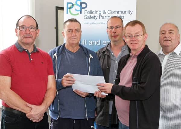 PCSP chairman Councillor Eric McGinley (second from right), accepting donations from local organisations for funding for ARCs & PYI projects.  From left are Martin Connelly and Cathal McCauley, with the Shantallow Community Residence Association, Max Beer, from The Playhouse and Michael Lynch, with Mens Action Network.  2216-3765MT.