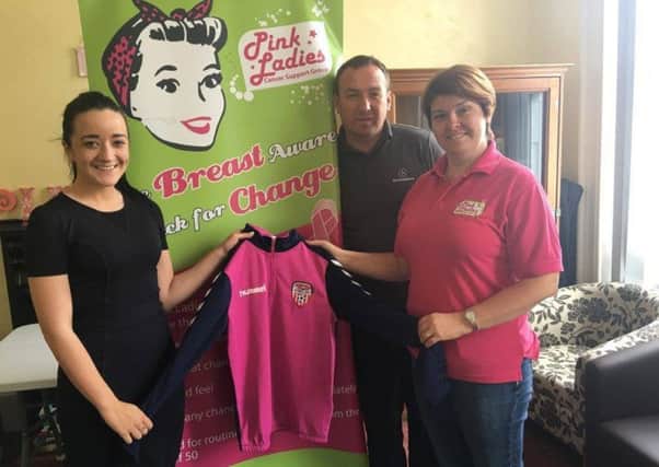 On the left, Orla Meenan commercial marketing officer for Derry City Football Club pictured with Maureen Collins, development worker with the Pink Ladies Cancer Support Group who are holding the specially designed pink top for the Derry City Legends v Glentoran Legends at Brandywell on June 4. Also pictured is legendary former Derry City player Liam Coyle.