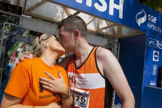 SEALED WITH A KISS!. . . .First time marathon runner, Derryman Joe Kennedy has a big kiss for girlfriend Eimear Kelly (Armagh) after he proposed on crossing the finishing line of Sunday's sse Airtricity Walled City Marathon in the city. DER2216MC039