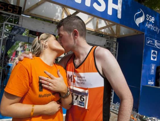 SEALED WITH A KISS!. . . .First time marathon runner, Derryman Joe Kennedy has a big kiss for girlfriend Eimear Kelly (Armagh) after he proposed on crossing the finishing line of Sunday's sse Airtricity Walled City Marathon in the city. DER2216MC039