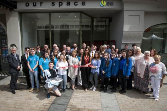 OUR SPACE OPENING. . . .The Mayor of Derry City and Strabane District Council pictured on Friday cutting the ribbon to officially open the new Our Space - City Centre Youth Provision offices at Waterloo Place. Included are representatives from local community groups, schools and Council. DER2116MC010