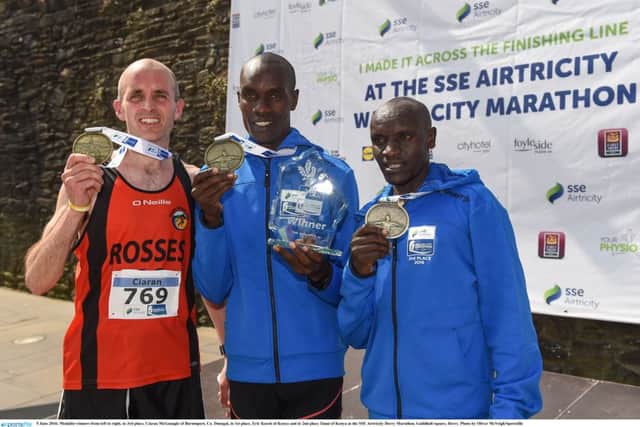 5 June 2016; Medalist winners from left to right, in 3rd place, Ciaran McGonagle of Burtonport, Co. Donegal, in 1st place, Eric Koech of Kenya and in 2nd place Tanui of Kenya at the SSE Airtricity Derry Marathon. Guildhall square, Derry. Photo by Oliver McVeigh/Sportsfile