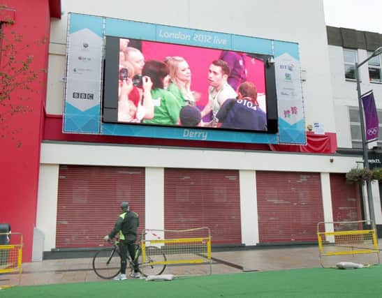 Watching the fastest paralympian in the world, Jason Smyth, take gold and break his own world record in the 100m, on the big screen in Derry oback in 2012. Jason greeted by his family after the race. Picture Margaret McLaughlin Â©