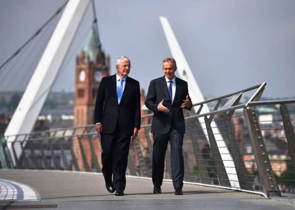 Former British Prime Ministers, John Major (left) and Tony Blair pictured on Derry's Peace Bridge yesterday afternoon. (Photo: Press Association)