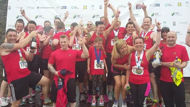 Star Running Club celebrate after all their members complete Sunday's marathon in Derry.
