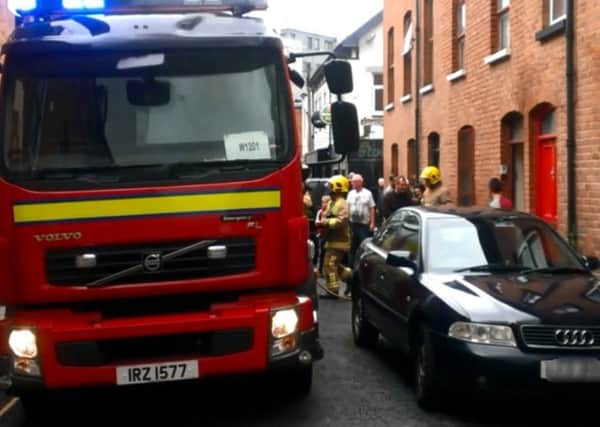 Fire-fighters arrive at the scene of a house fire in Derry city centre.