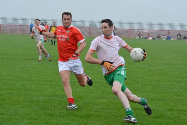 Drum's James McCartney comes away with possession as  Sean Dolan's Ciaran Wilkinson gives chase during Friday night's game at Piggery Ridge. DER2316MC031