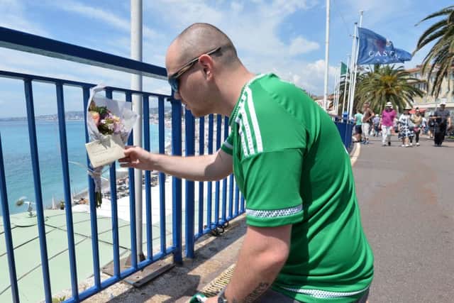 N Ireland Fans visit  the scene where  Northern Ireland fan  died in Nice,  Darren Rodgers, who was 24 and from Ballymena, was on his own and fell about eight metres from a promenade onto a rocky beach.  Flowers , A Flag and scarf have been left by Supporters on Monday.
Pic Colm Lenaghan/Pacemaker